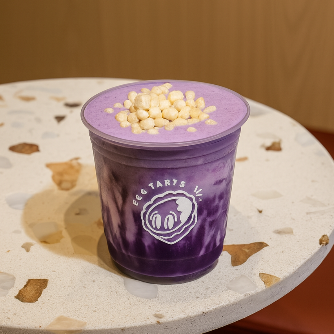 Purple drink with rice crispies in a cup on a decorative surface